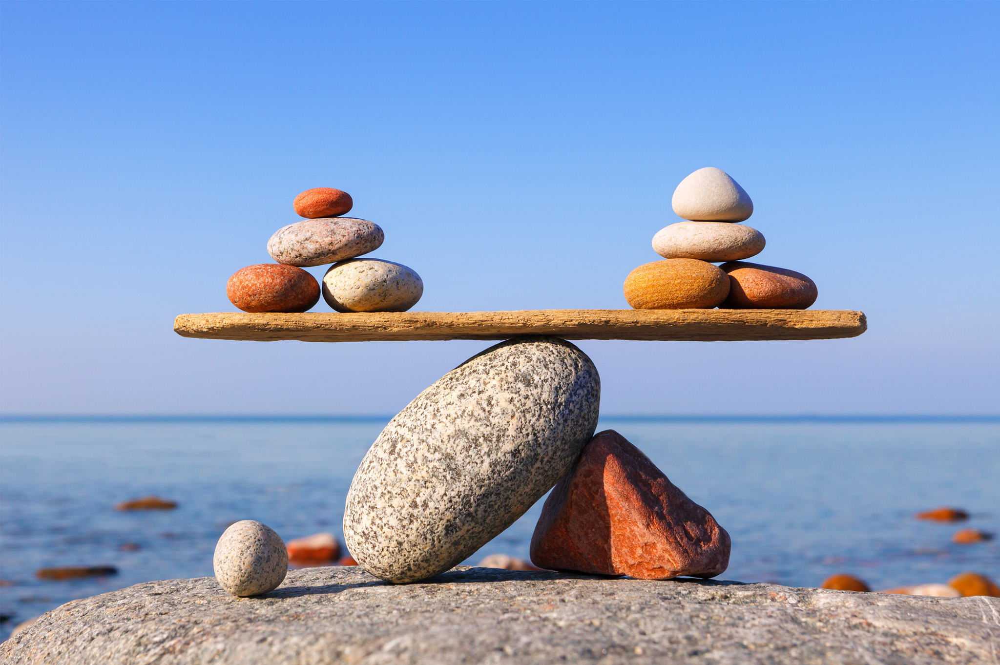 image of beach rocks balancing with ocean in background